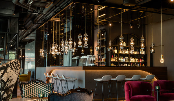 Spindle Shade and Spindle pendant lights by Rothschild & Bickers hanging over a bar in Motel One Salzburg Mirabell