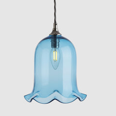 Blue glass pendant light on a white background