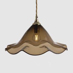 Pendant light with wavy smoke bronze glass shade on a white background