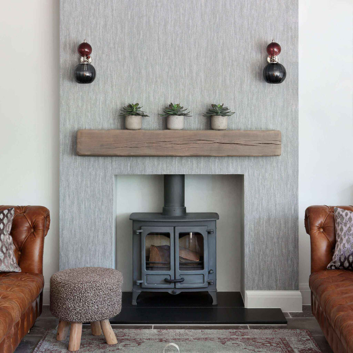 Glass wall lights either side of a fireplace