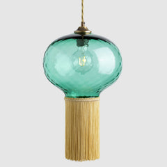 Decorative pendant light with a glass shade and fringe on a white background