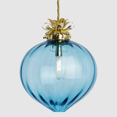 Blue glass pendant light with gold fixture on a white background