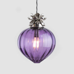 Purple glass pendant light with metallic fixture on a white background