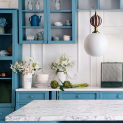 Ochre and white striped glass pendant light over kitchen island