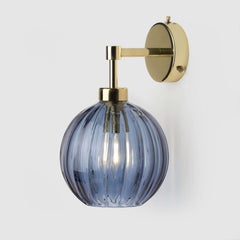 Denim blue fluted glass wall sconce in polished brass