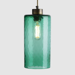 Textured Green glass pendant light with in a cylinder shape on white grey background