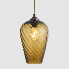 Amber/Sargasso twisted optic glass pendant light on a white background
