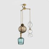 Metal three armed chandelier with decorative coloured glass pendant lighting and floral metalwork