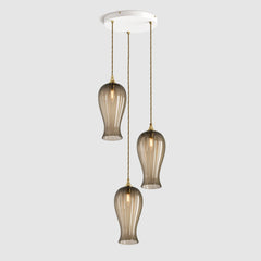 Group of Long ribbed bronze coloured glass decorative pendant lights with brass fitting and fabric covered flex, hanging on a ceiling plate