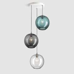 Group of blue, clear and grey plain sphere glass pendant lights on ceiling plate with silver fittings and fabric covered flex