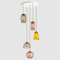 Amber and warm brown diamond glass pendant lights on a ceiling plate with brass fittings and fabric covered flex