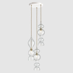 Spindle shaped clear ribbed glass pendant lights hanging on ceiling plate with fabric covered twisted flex
