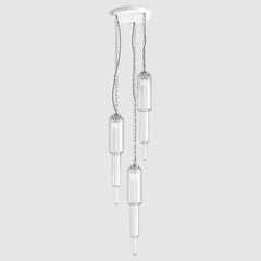 Group of clear ribbed art deco style pendant lights with decorative chain fitting and twisted fabric covered flex hanging on a ceiling plate