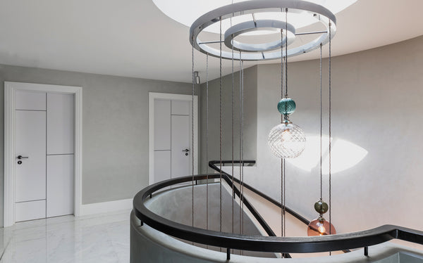 Lighting suspension ring solution by Rothschild & Bickers hanging pendant lights in stairwell