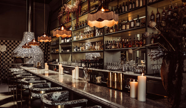 Vintage Pendant lights by Rothschild & Bickers hanging over restaurant bar west hollywood