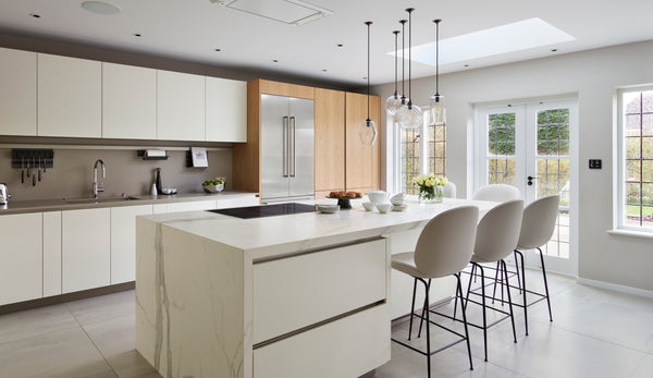 Pick-n-Mix standard pendants in clear glass hanging over kitchen island by Neil Lerner Design