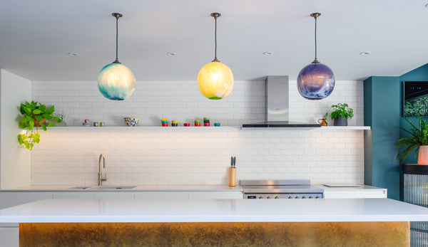 Mineral Pendant lighting by Rothschild & Bickers hanging over a kitchen island by Sustainable Kitchens