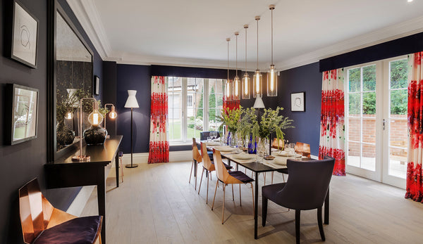 Empire Tall Pendant lights hanging over dining table, design by Studio Hooten