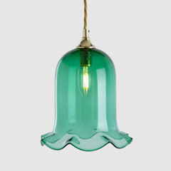 Green glass pendant light with gold fixture on a white background