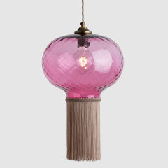 Pink glass ceiling light with tassel on a white background