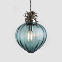 Blue glass pendant light with metallic fixture on a white background