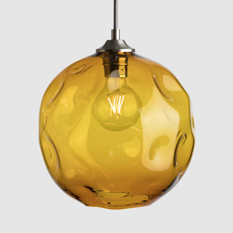 Amber organic shaped clear glass suspension pendant lights with brushed nickel fittings and fabric covered flex