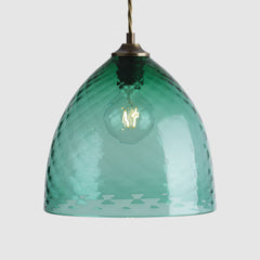 Textured Green glass pendant light in bowl shape on a white background