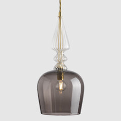 Smoky glass pendant light with gold accents on a white background