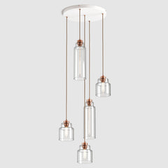 Group of Stepped clear glass decorative pendant lights with copper fittings and fabric covered flex, hanging on ceiling plate