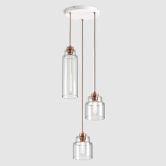 Group of Stepped clear glass decorative pendant lights with copper fittings and fabric covered flex, hanging on ceiling plate