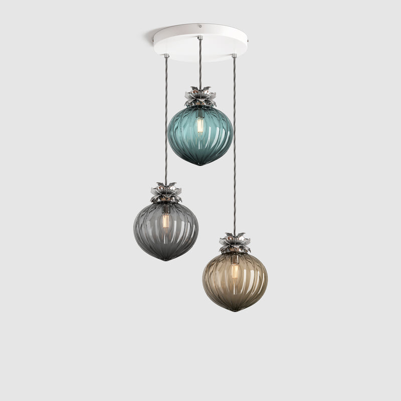 Group of Teal, Grey and bronze coloured pendant lights in ribbed glass and decorative floral metalwork hanging on a ceiling plate