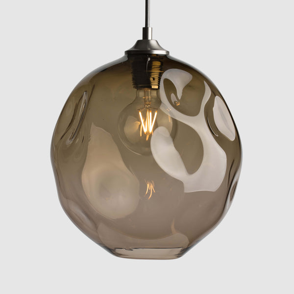 Bronze organic shaped clear glass suspension pendant lights with brushed nickel fittings and fabric covered flex