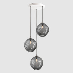 Clear grey organic shaped glass pendant lights hanging on ceiling plate with fabric covered flex