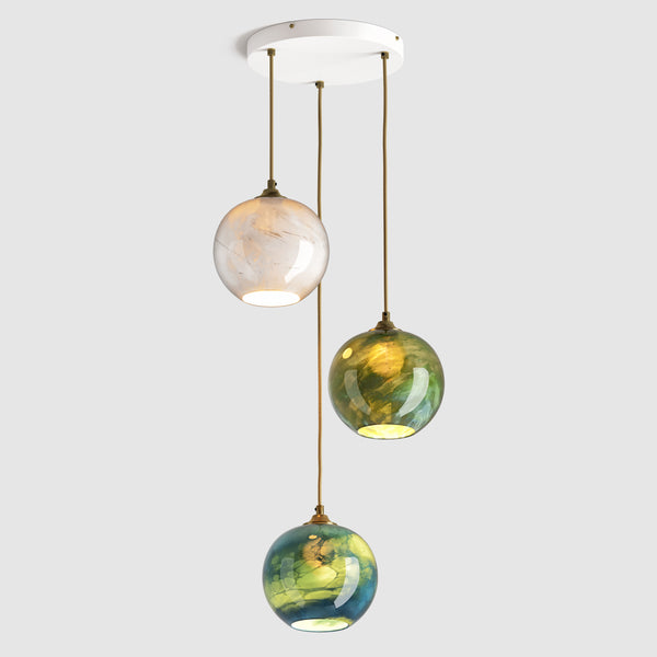 round blue, green and white marble glass pendant lights on ceiling plate with fabric covered flex