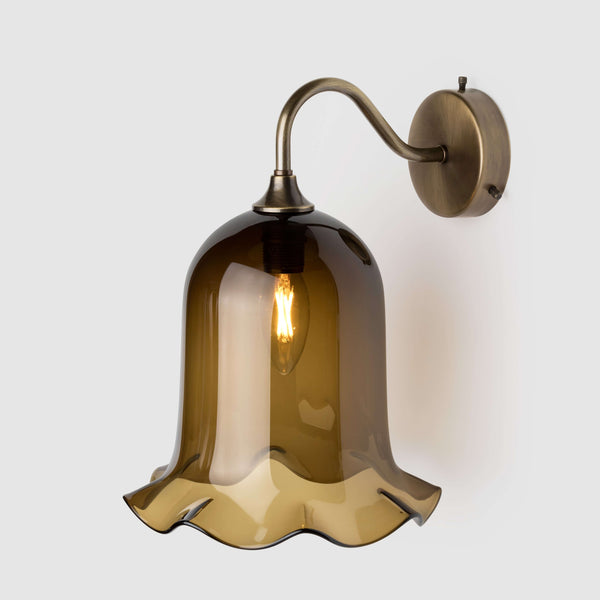 Sargasso green blown glass light shade with frilled bottom on an antique brass wall arm