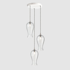 Group of Long ribbed clear glass decorative pendant lights with brass fitting and fabric covered flex, hanging on a ceiling plate