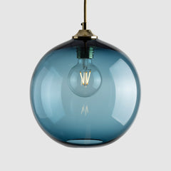 Denim blue clear plain glass sphere pendant light with brass fittings and fabric covered flex, filament bulb