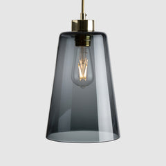 Grey pot shaped pendant light in clear glass with brass fittings and fabric covered flex