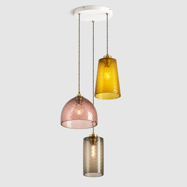 Amber and warm brown diamond glass pendant lights on a ceiling plate with brass fittings and fabric covered flex