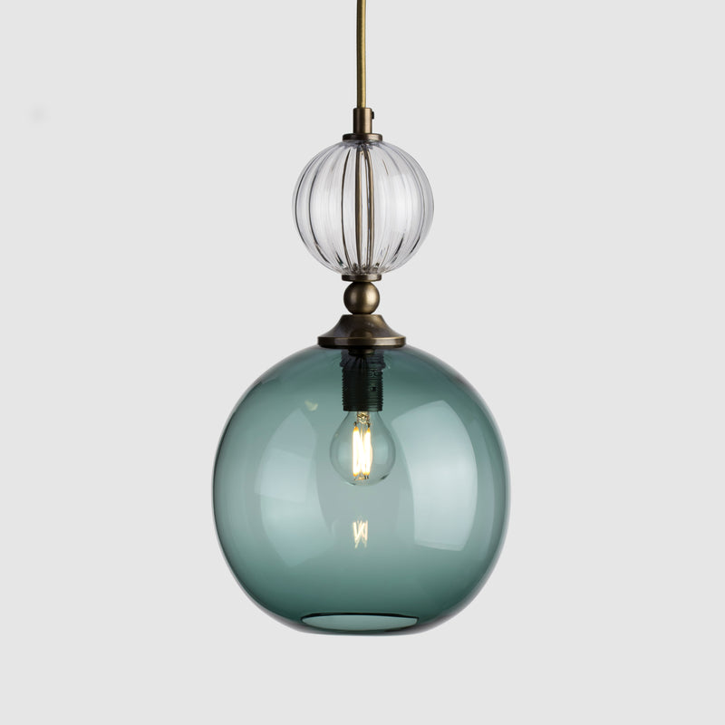 Round coloured ribbed glass pendant light with decorative metal and fabric covered flex