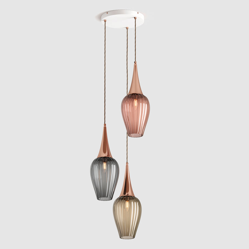 Group of ribbed glass pendant lights in tea, grey and bronze colours hanging on a ceiling plate