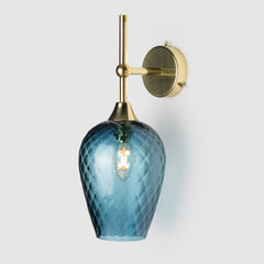Coloured diamond pattern blown glass ball  light shade on a polished brass wall arm