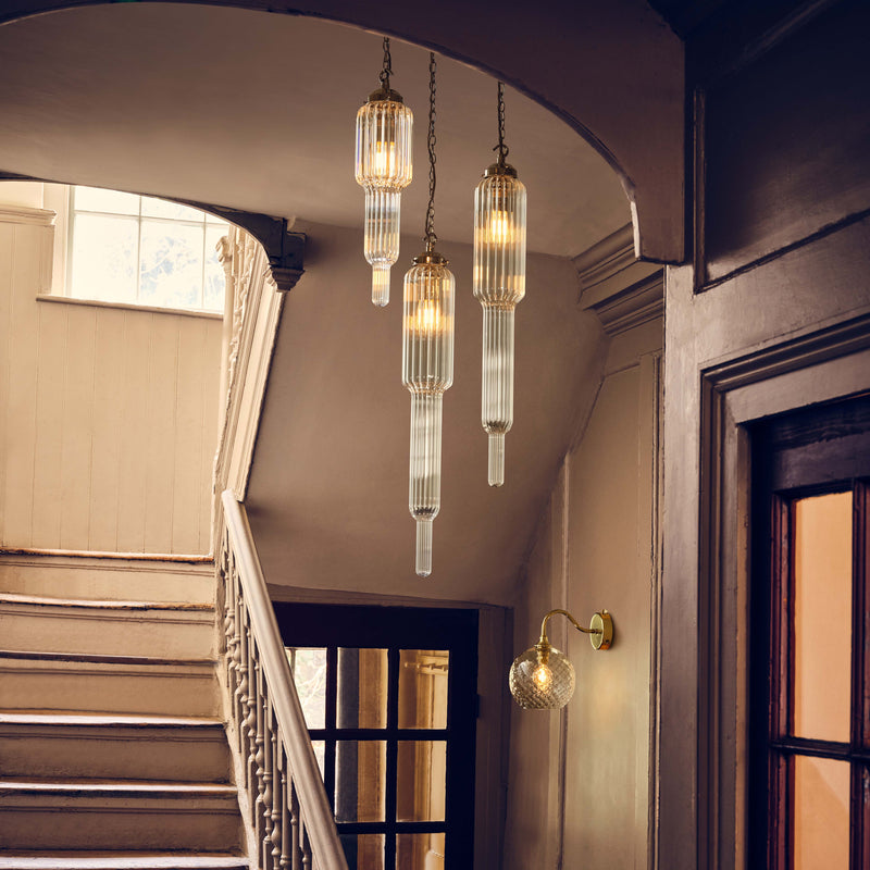 Clear ribbed pendant lighting lamps hanging in Victorian Stairwell
