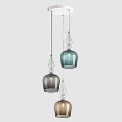 Group of Tall cloche shaped glass pendant lights in Teal, grey and bronze with decorative clear ribbed glass spindle feature, hanging on ceiling plate with fabric covered flex
