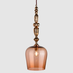 Peach coloured glass pendant light with decorative polished copper metal detail and fabric covered flex