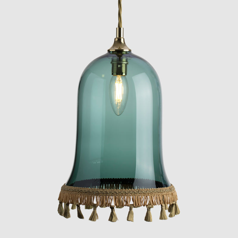 Teal glass decorative pendant light with gold fabric lamp tassel and twisted flex
