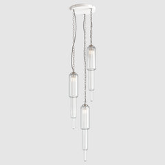 Group of clear ribbed art deco style pendant lights with decorative chain fitting and twisted fabric covered flex hanging on a ceiling plate