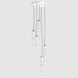 Group of art deco style clear ribbed glass pendant lights hanging on a ceiling plate