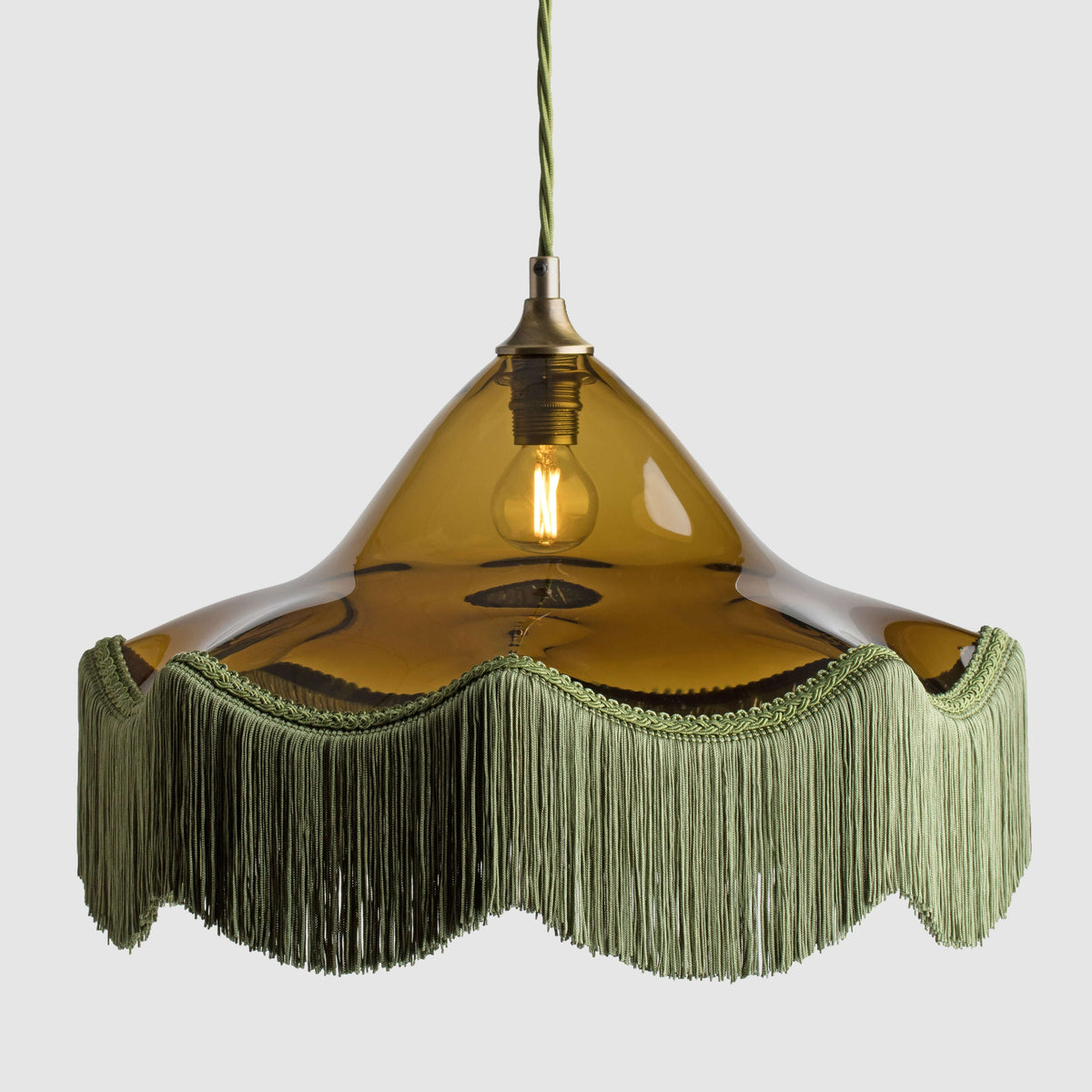 Green coloured frilled glass decorative pendant light with fabric lamp fringe and twisted flex